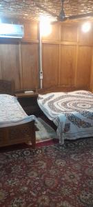 ein Zimmer mit zwei Betten in einem Zimmer mit in der Unterkunft Mashal in Srinagar