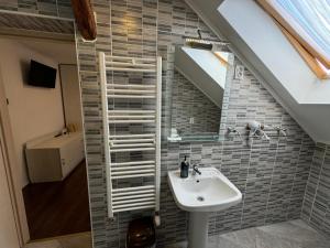 a bathroom with a sink and a staircase at TOMISLAV in Zagreb