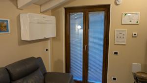 a living room with a heater and a couch and a window at La Stalletta in Menaggio