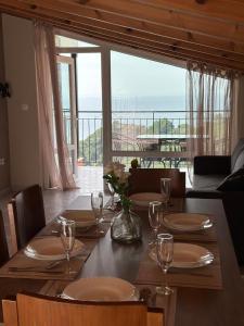 a dining room table with a view of the ocean at Galini Seaview Kontogialos in Pelekas