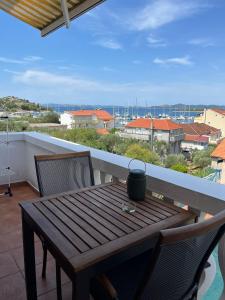 a wooden table and chairs on a balcony at Grgo Apartments in Drage