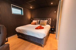 a bedroom with a large bed in a room at Tiny boat house #2 in Garnwerd