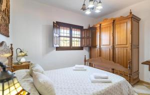 a bedroom with a bed and a wooden cabinet at Villa La Colina in Torrox +10 photos