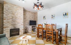 a living room with a fireplace and a table and chairs at Villa La Colina in Torrox