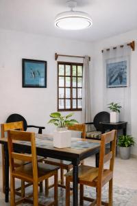a dining room with a table and chairs at Paradise Renewed Beach House for Deep Relaxation in El Cuyo