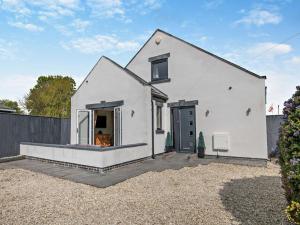 a white house with a fireplace in a yard at 2 Bed in Middlesbrough oc-75226 in Great Ayton