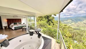 a bath tub in a room with a bedroom at Hotel El Mirador del Cocora in Salento