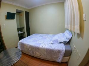 a small bedroom with a bed and a window at Hostal Aurora a 3 cuadras de la Plaza de Armas in Cajamarca +10 photos