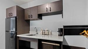 a kitchen with a sink and a refrigerator at Studio 6 Richmond, VA - Airport in Sandston