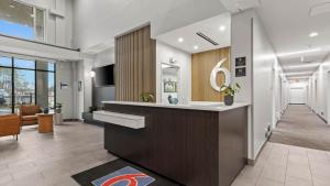 an office lobby with a reception desk and a hallway at Studio 6 Richmond, VA - Airport in Sandston