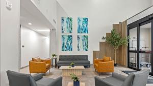 a living room with a couch and chairs and a table at Studio 6 Richmond, VA - Airport in Sandston +27 photos