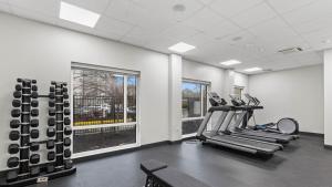 a gym with treadmills and machines in a room at Studio 6 Richmond, VA - Airport in Sandston