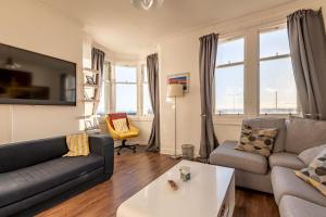 a living room with a couch and a table at Harbour View - Anstruther in Anstruther