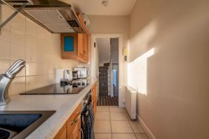 a kitchen with a sink and a counter top at Harbour View - Anstruther in Anstruther