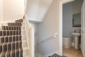 a staircase in a bathroom with a sink and a toilet at Harbour View - Anstruther in Anstruther +18 photos