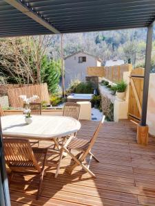 a patio with a table and chairs on a deck at Maison Corse avec SPA - La Casa Serena in Ortiporio +14 photos