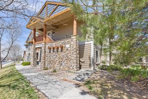 a house with a stone wall at Beacon at the Lakes Cozy 2b2b, Grnd Level Condo in Windsor