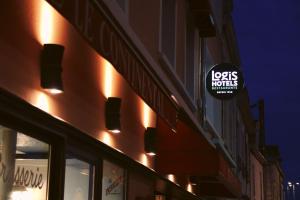 a sign on the side of a building with lights at Logis Hôtel Restaurant Le Continental in Châteauroux