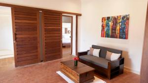 a living room with a couch and a coffee table at Zahari Oceanfront in Msambweni