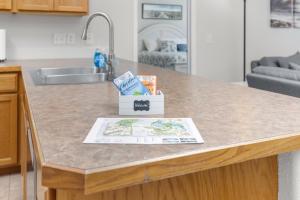 a kitchen counter with a book sitting on top of it at Beacon at the Lakes Cozy 2b2b, Grnd Level Condo in Windsor +23 photos