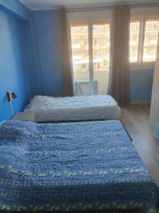 a bedroom with two beds and a window at Hôtel de la poste in La Celle-sous-Gouzon