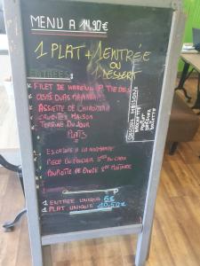 a chalkboard sign with a menu on it at Hôtel de la poste in La Celle-sous-Gouzon