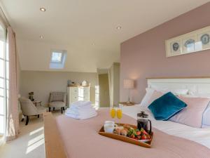 a bedroom with a bed with a tray of fruit on it at 3 Bed in Stokesley oc-77667 in Carlton