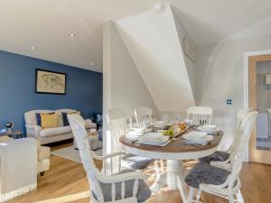 a dining room with a table and white chairs at 3 Bed in Stokesley oc-77667 in Carlton