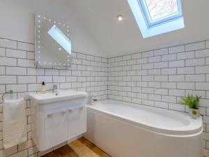 a white bathroom with a tub and a sink at 3 Bed in Stokesley oc-77667 in Carlton +18 photos