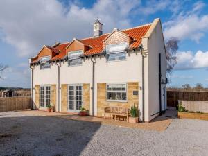 a large white house with an orange roof at 3 Bed in Stokesley oc-77667 in Carlton