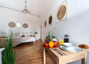 a room with a table with a bowl of fruit on it at Celine Prague Luxury Hostel in Prague