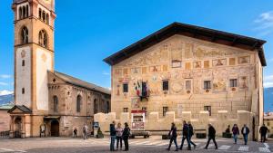 a group of people walking in front of a building at Isolden Green Srl Berlanda Mountain suites in Cavalese