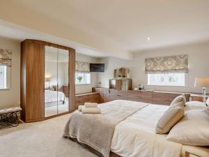 a large bedroom with a large bed and a bathroom at 5 Bed in Leeds oc-91355 in Sherburn in Elmet