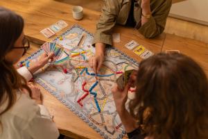 a group of people playing a board game on a table at Hôtel Life Marseille VP - Vieux Port in Marseille