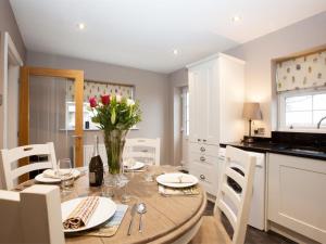 a kitchen with a table with a vase of flowers at 2 Bed in Stokesley oc-g0072 in Carlton
