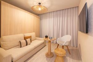 a living room with a couch and a table at Hôtel Life Marseille VP - Vieux Port in Marseille