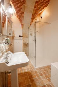 a bathroom with a sink and a shower at Le Domaine de Fleury - Pierres d'Histoire in Fleury-en-Bière +31 photos