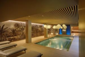 a large swimming pool in a building with at Villa Miliani in Fabriano