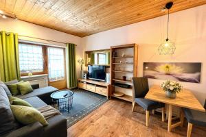 a living room with a couch and a table at Ferienwohnung Forggensee-Blick in Schwangau