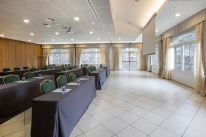 a row of tables and chairs in a room at Hotel Sant Gothard by Nexta in Arinsal +54 photos