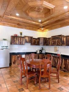a kitchen with a table and chairs and a refrigerator at Twins Villa Đà Lạt in Khu Chi Lăng