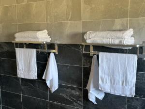 a bathroom with white towels hanging on a wall at Ocean Gem in Bakau +48 photos
