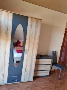 a bedroom with a bed and a mirror at Zschirnsteinblick in Schöna