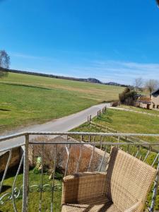 a chair sitting on a rail next to a road at Zschirnsteinblick in Schöna