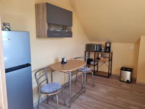 a kitchen with a table and chairs and a refrigerator at Zschirnsteinblick in Schöna
