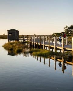 a person walking across a bridge over a body of water at Maré do Bairro Studio Beira Mar Aveiro in Aveiro