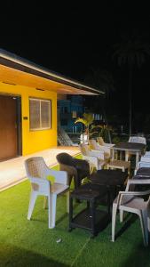 a row of chairs and tables on a lawn at Arbuda inn in Mount Ābu