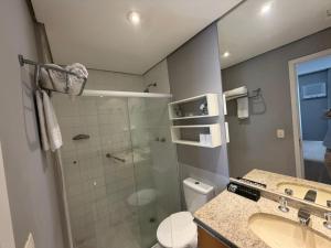 a bathroom with a shower and a toilet and a sink at Hotel Flat Biena Parque Ibirapuera 1101 incluso estacionamento in São Paulo