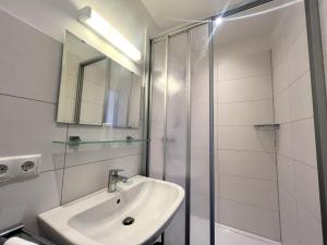 a bathroom with a sink and a shower at Hotel an der Hauptallee in Bad Pyrmont +15 photos