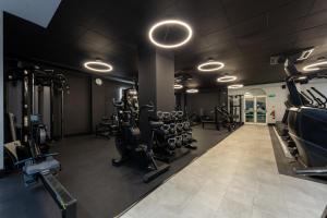 a gym with treadmills and machines in a room at Holiday Inn Corby Kettering Hotel & Spa in Corby